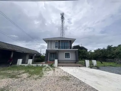 Modern two-story house with spacious driveway and lush greenery, perfect for family living.