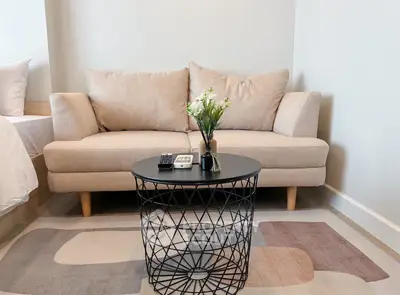 Cozy living room with beige sofa and modern round coffee table