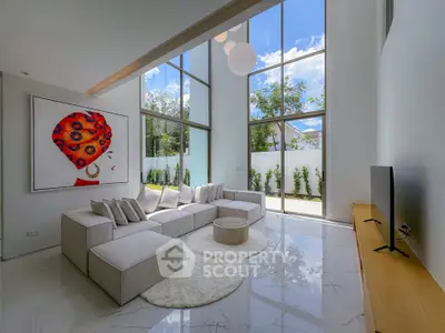 Luxurious modern living room with high ceilings, large windows, and elegant decor.