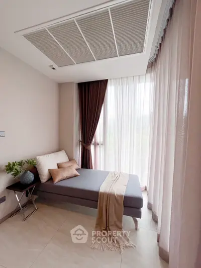 Elegant small living space with modern decor and natural light