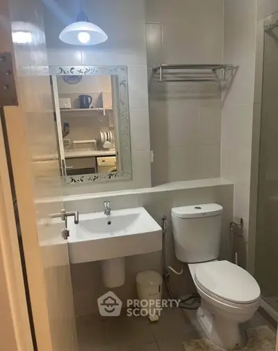 Modern bathroom with sleek fixtures and a glass shower enclosure.