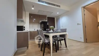 Modern dining area with sleek kitchen and elegant table setting