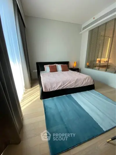 Modern bedroom with stylish decor and large window for natural light