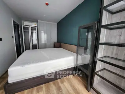 Modern bedroom with sleek design and ample storage in a stylish apartment.