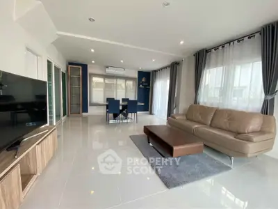 Spacious modern living room with sleek furniture and large windows