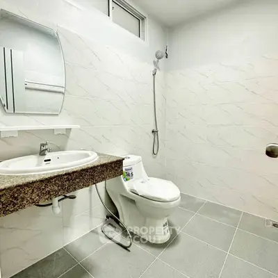 Modern bathroom with sleek fixtures and elegant tile design.
