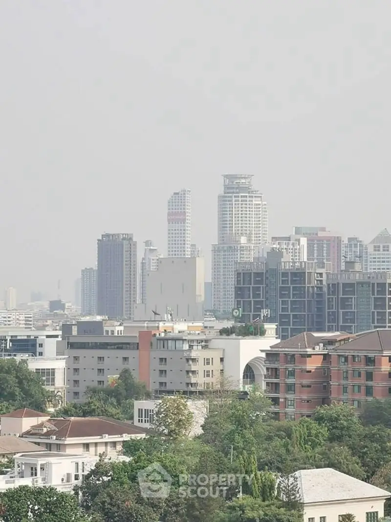 Stunning cityscape view showcasing modern high-rise buildings and lush greenery, perfect for urban living.