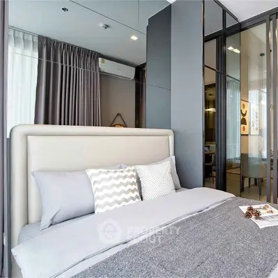 Modern bedroom with stylish decor and large windows for natural light.