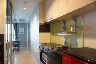 Modern kitchen with sleek appliances and open layout in stylish apartment