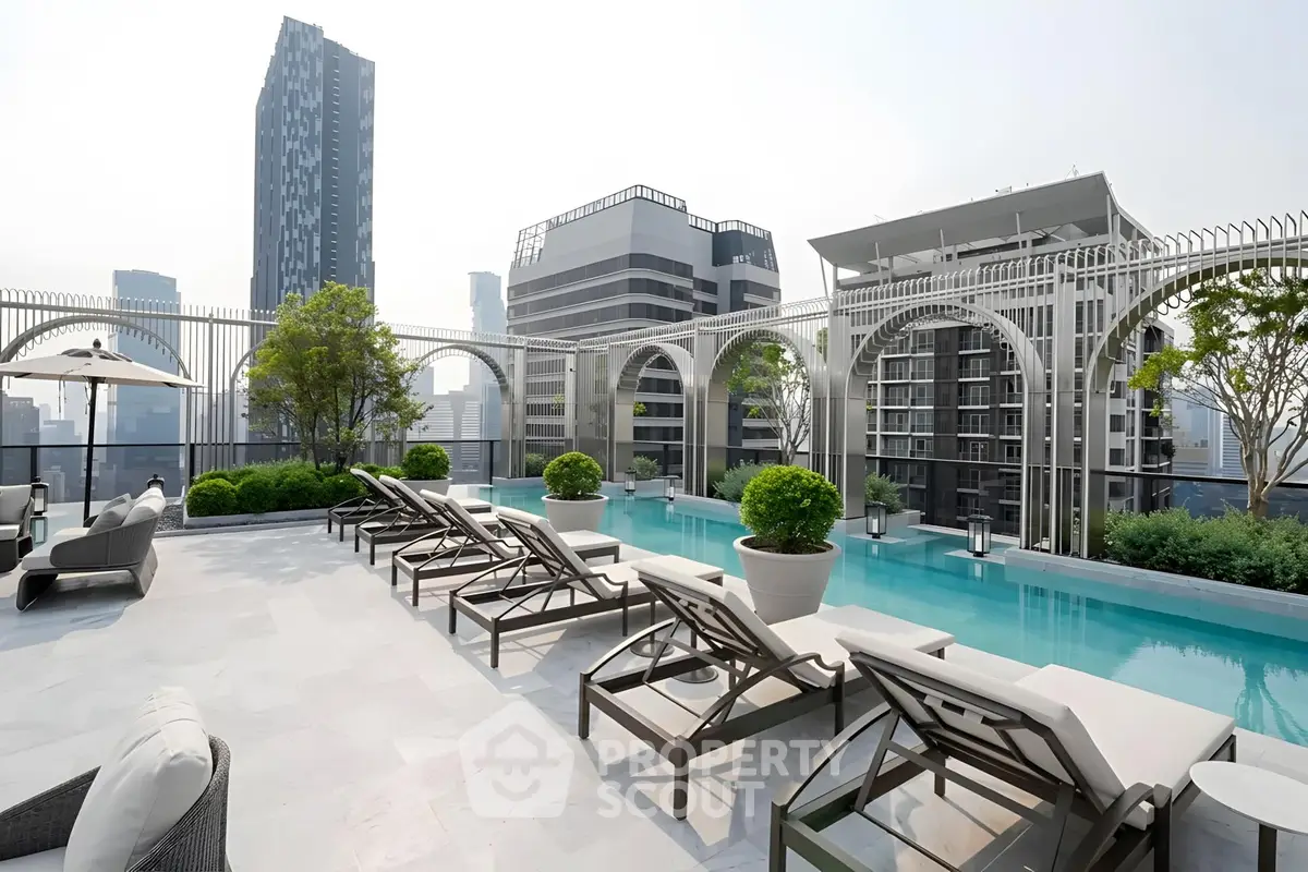 Luxurious rooftop pool with city skyline views and elegant lounge chairs.