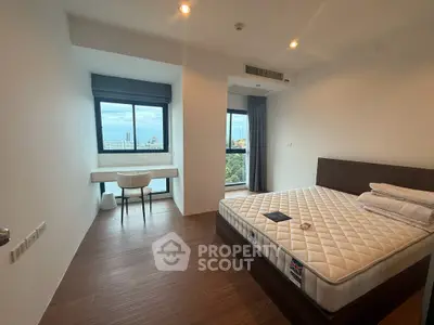 Spacious bedroom with a stunning city view, featuring a modern design and ample natural light.