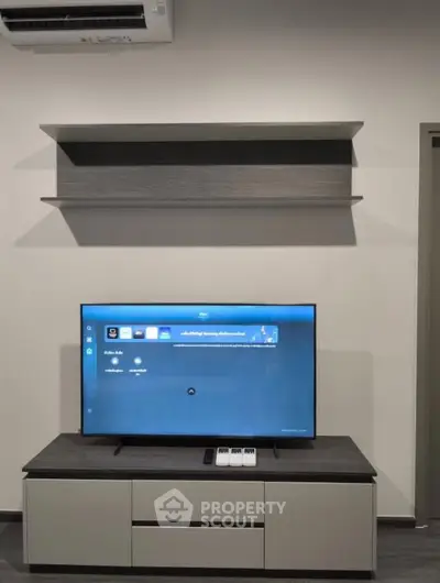 Modern living room with sleek TV setup and minimalist shelving