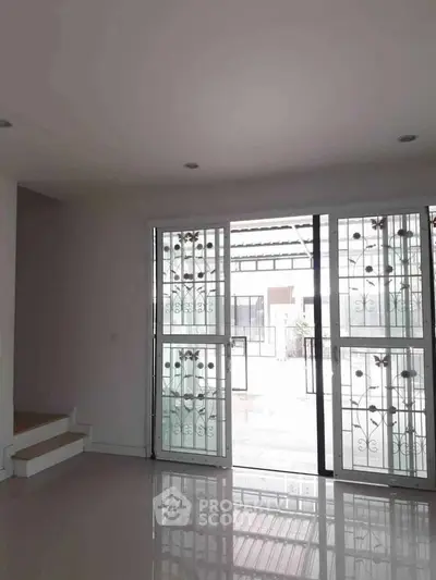 Spacious interior with large windows and modern design, perfect for natural light.