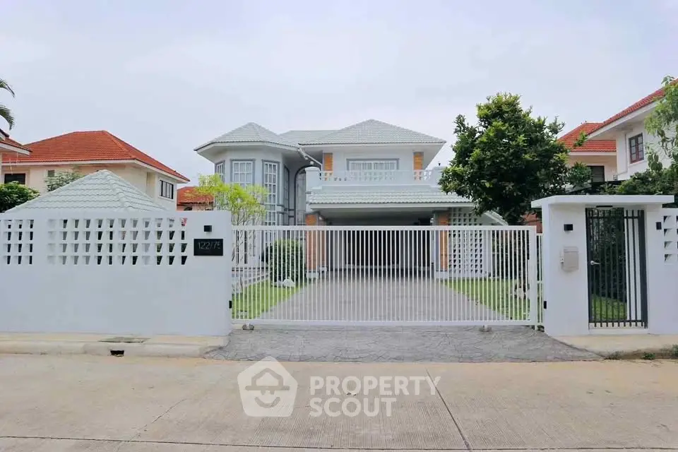 Stunning modern house with gated entrance and lush greenery, perfect for family living.