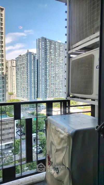 Stunning urban view from a balcony with modern high-rise buildings and air conditioning units.