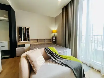 Modern bedroom with large window and stylish decor in a high-rise apartment.