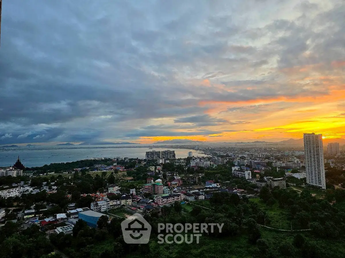 Stunning cityscape view at sunset with lush greenery and skyline.
