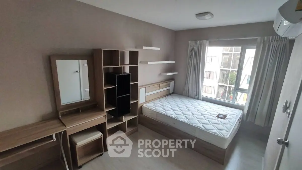 Modern bedroom with minimalist furniture and large window for natural light.