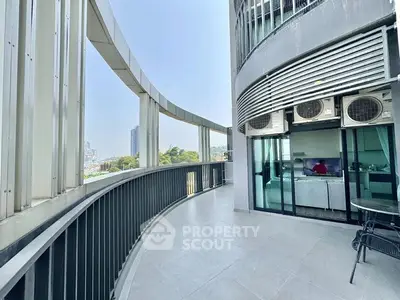 Spacious curved balcony with city view and modern design