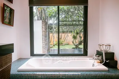 Luxurious bathroom with garden view and elegant bathtub in modern home