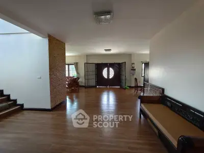 Spacious living room with elegant wooden flooring and stylish furniture