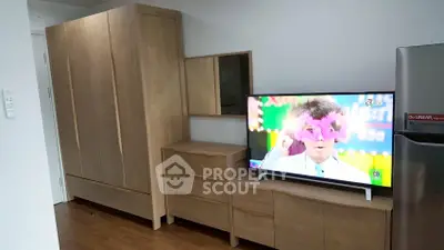 Modern living room with sleek wooden furniture and flat-screen TV