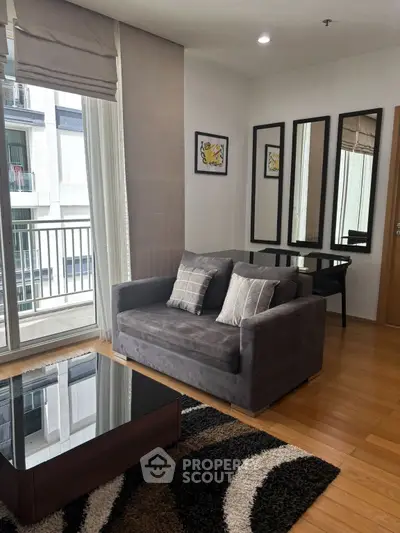 Modern living room with stylish decor and balcony view in urban apartment