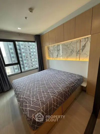 Modern bedroom with large window and stylish decor in urban apartment