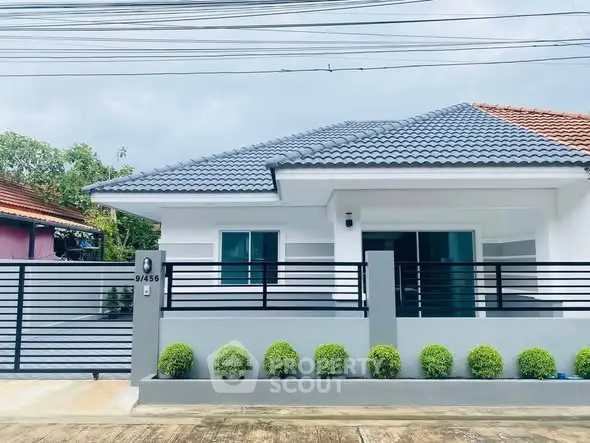 Charming modern house with sleek design and lush greenery in a serene neighborhood.