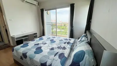 Spacious bedroom with balcony and city view in modern apartment