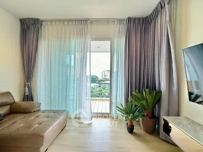 Spacious living room with modern decor and balcony view