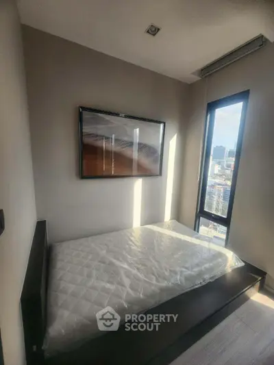 Modern bedroom with large window offering city view and stylish decor