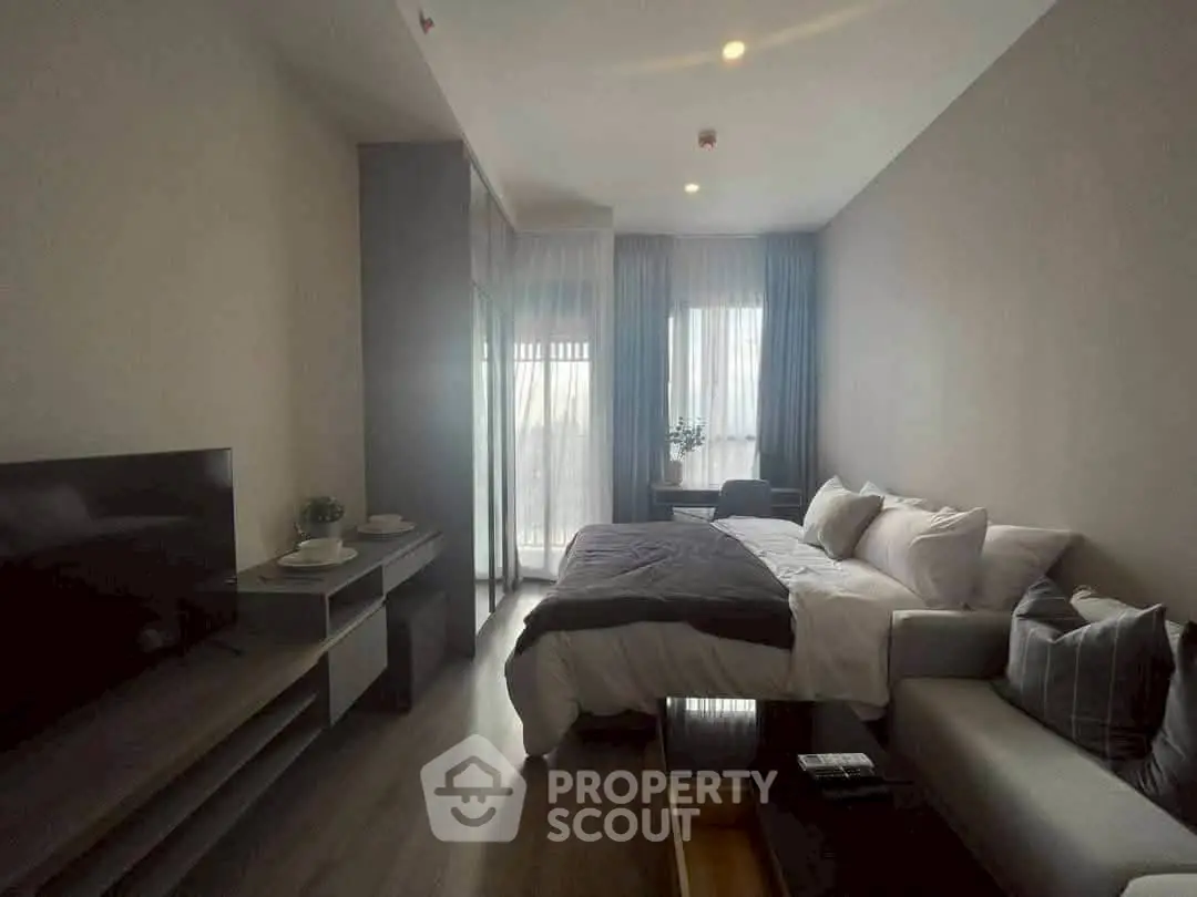 Modern living room with cozy sofa, TV, and elegant decor