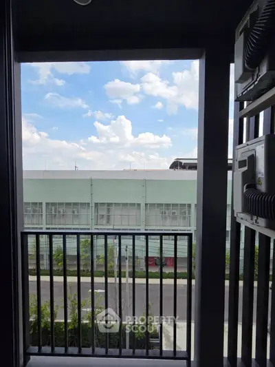 Charming balcony view with clear skies and modern architecture, perfect for urban living.