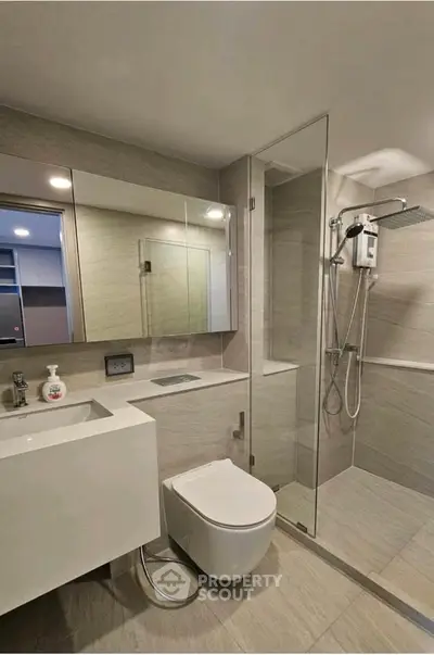 Modern bathroom with sleek fixtures and glass shower enclosure