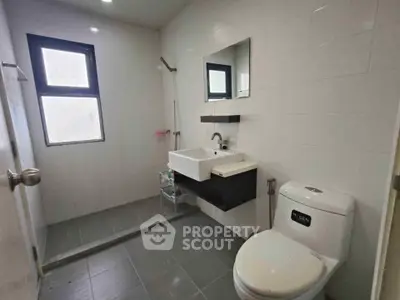 Modern bathroom with sleek fixtures and large window for natural light.