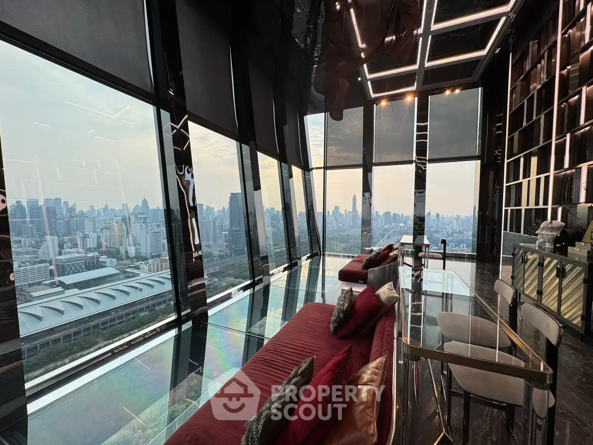 Luxurious high-rise living room with panoramic city views and modern interior design.