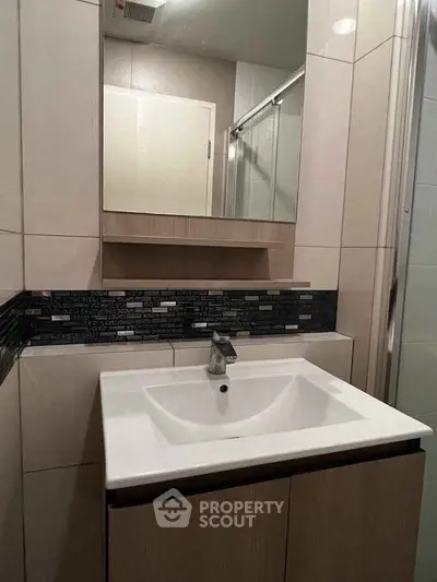 Modern bathroom with sleek sink and stylish tile backsplash