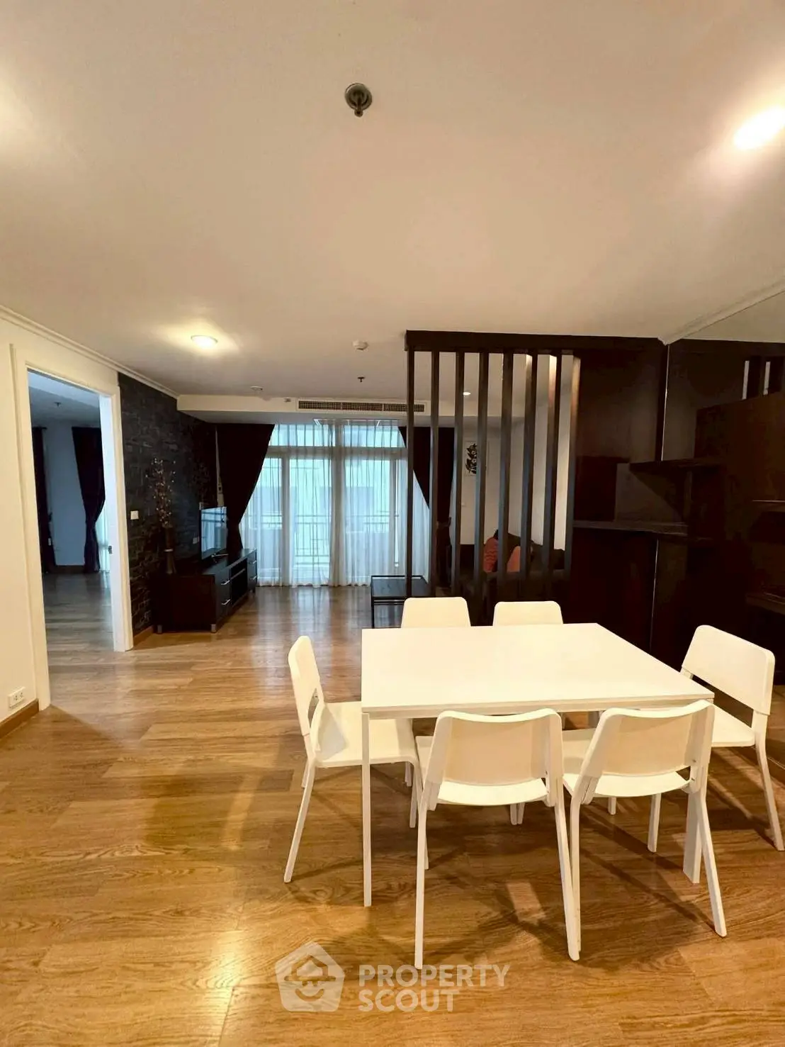 Spacious modern living room with dining area and wooden flooring