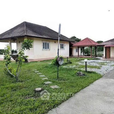 Charming single-story home with spacious garden and covered patio, perfect for outdoor relaxation.