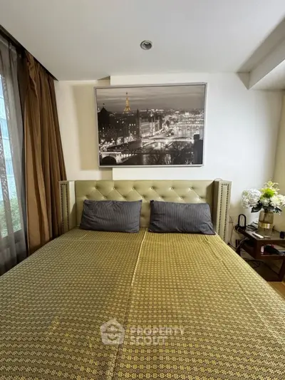 Cozy bedroom with elegant decor and large bed, featuring stylish artwork and soft lighting.