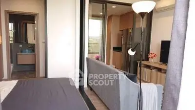 Modern apartment interior with open layout, featuring cozy living room and stylish kitchen.