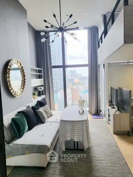 Modern loft living room with high ceiling and city view, featuring stylish decor and ample natural light.
