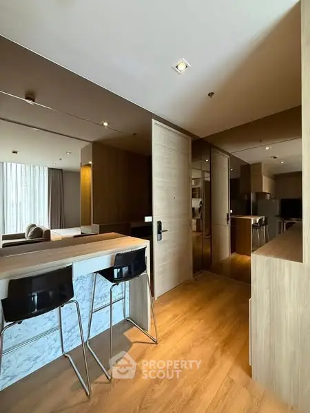 Modern open-plan living area with stylish kitchen and bar seating