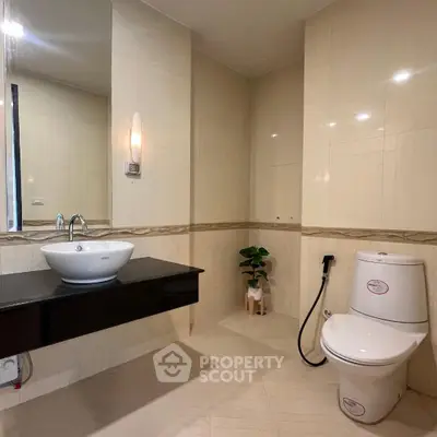 Modern bathroom with sleek fixtures and elegant lighting in a contemporary real estate property.