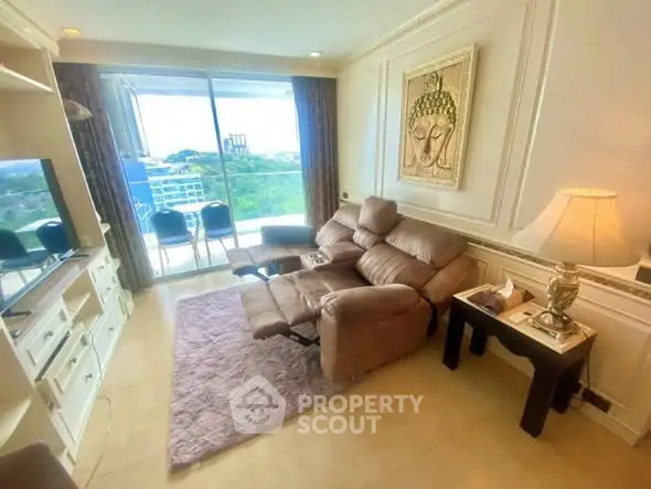 Luxurious living room with reclining sofa and stunning city view from balcony.