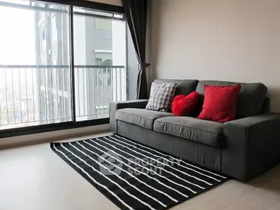 Modern living room with cozy sofa and city view from large window.