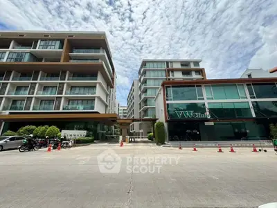 Modern apartment complex with sleek architecture and spacious surroundings.