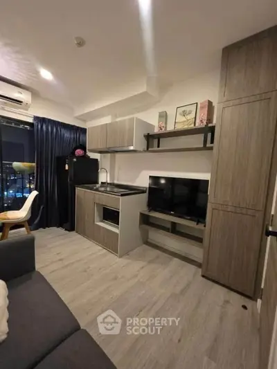 Modern compact living room with integrated kitchen and stylish decor