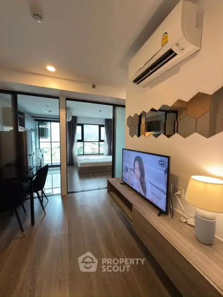 Modern apartment interior with open layout, featuring a cozy living area and stylish decor.